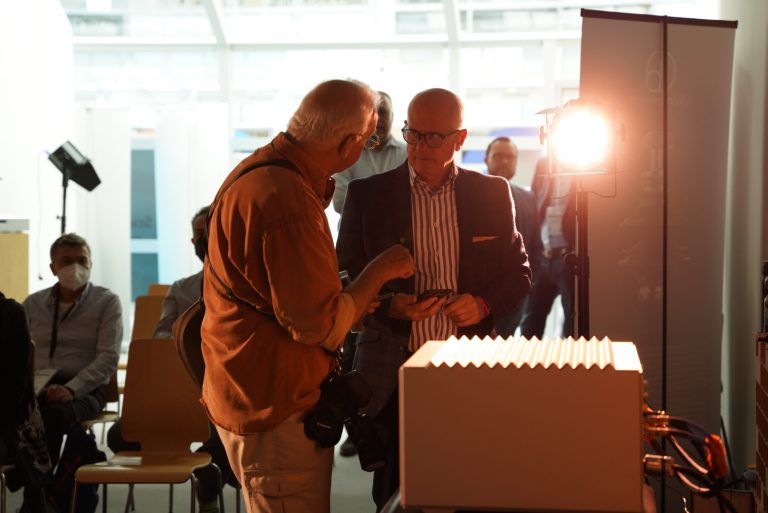 Wilson Benesch Design Director explaining the new GMT System® Turntable to a guest attending the Munich HIGH END 2022