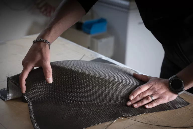 The multi-axial Carbon Fibre - PET material that was designed and developed by Wilson Benesch is woven specially for the company. It is a unique weave that allows complex forms to be made from the material. Seen here forming an Endeavour 3zero carbon fibre - PET top. Also used to make the IGx diaphragm